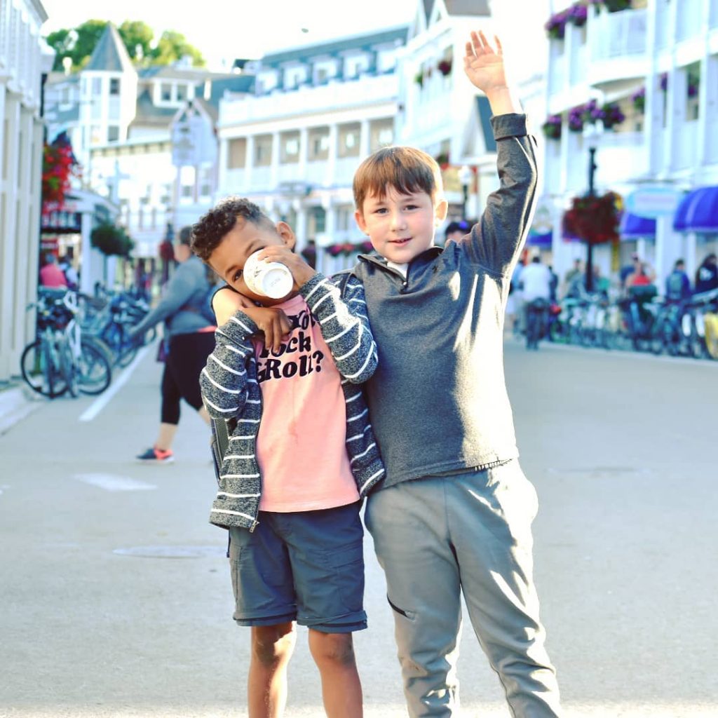 Two Little Boys Posing Together for Photo in Downtown Mackinac