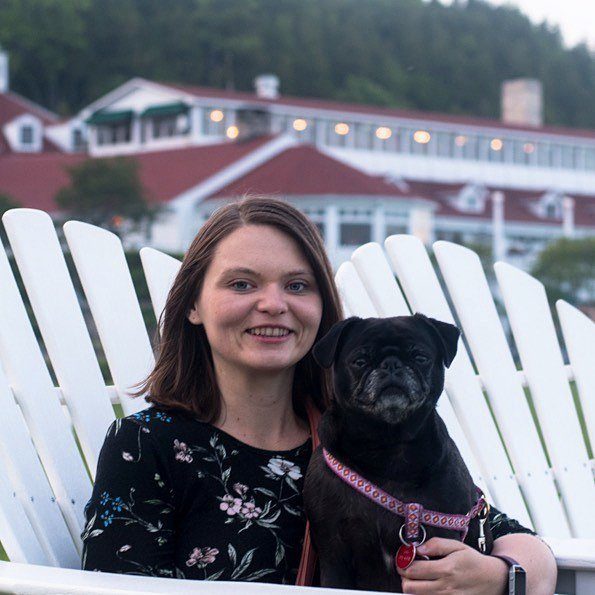 Dog With Owner on Lounge Chair – Mackinac Island Tourism Bureau