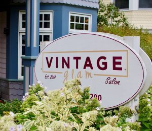A sign for Vintage Glam salon on Mackinac Island's Market Street