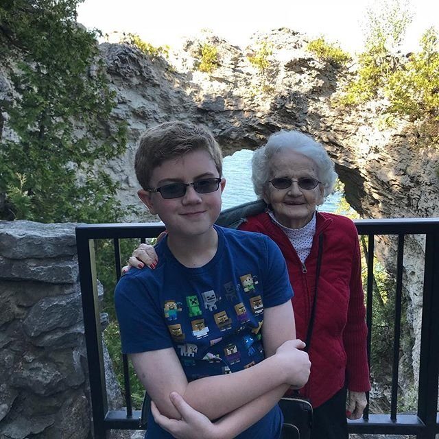 Grandmother with Grandson in Sunglasses Taking Photo on Mackinac Island 